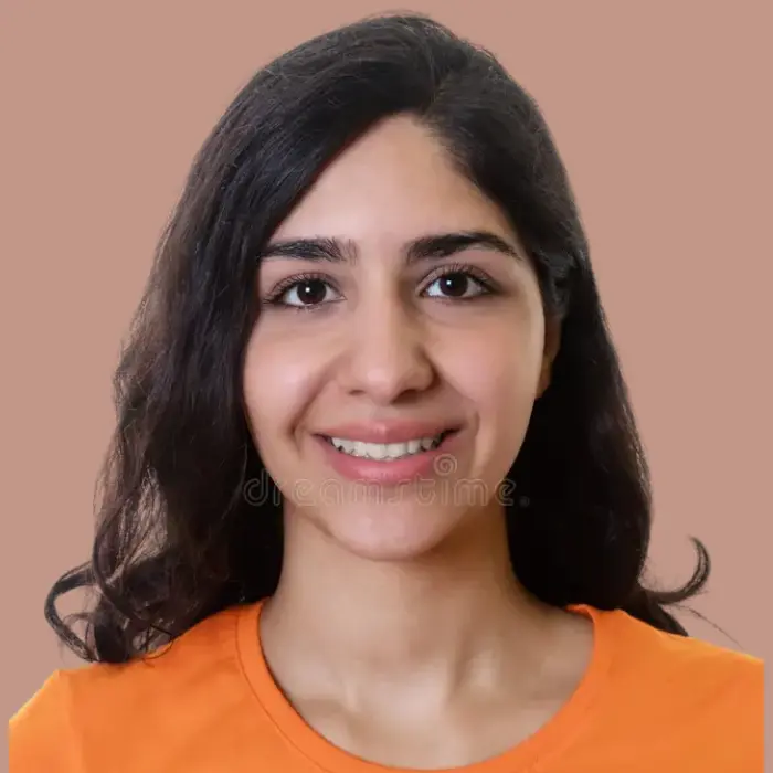 It is image of female dentist with open hairs wearing orange T-shirt.