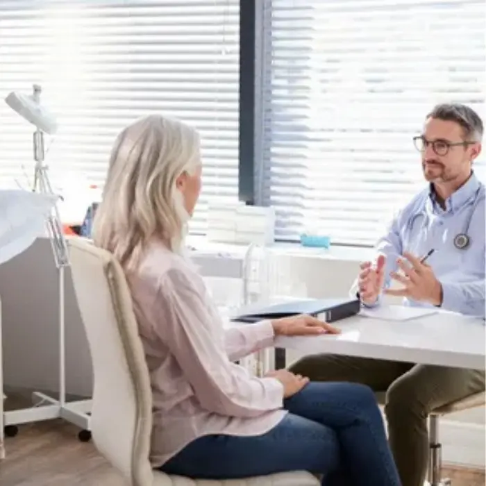 It the image of a make doctor taking to a female patient,