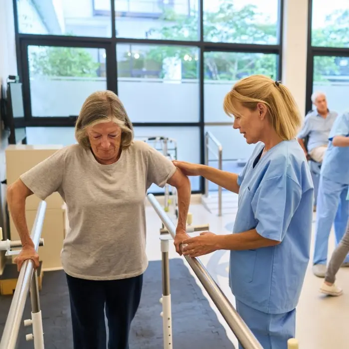 It is an image of a female Physiotherapist helping a female patient.